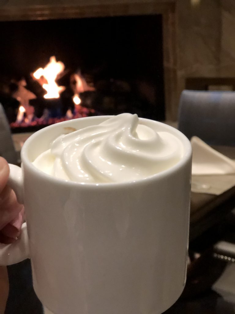 hot chocolate with whipped cream in a white mug
