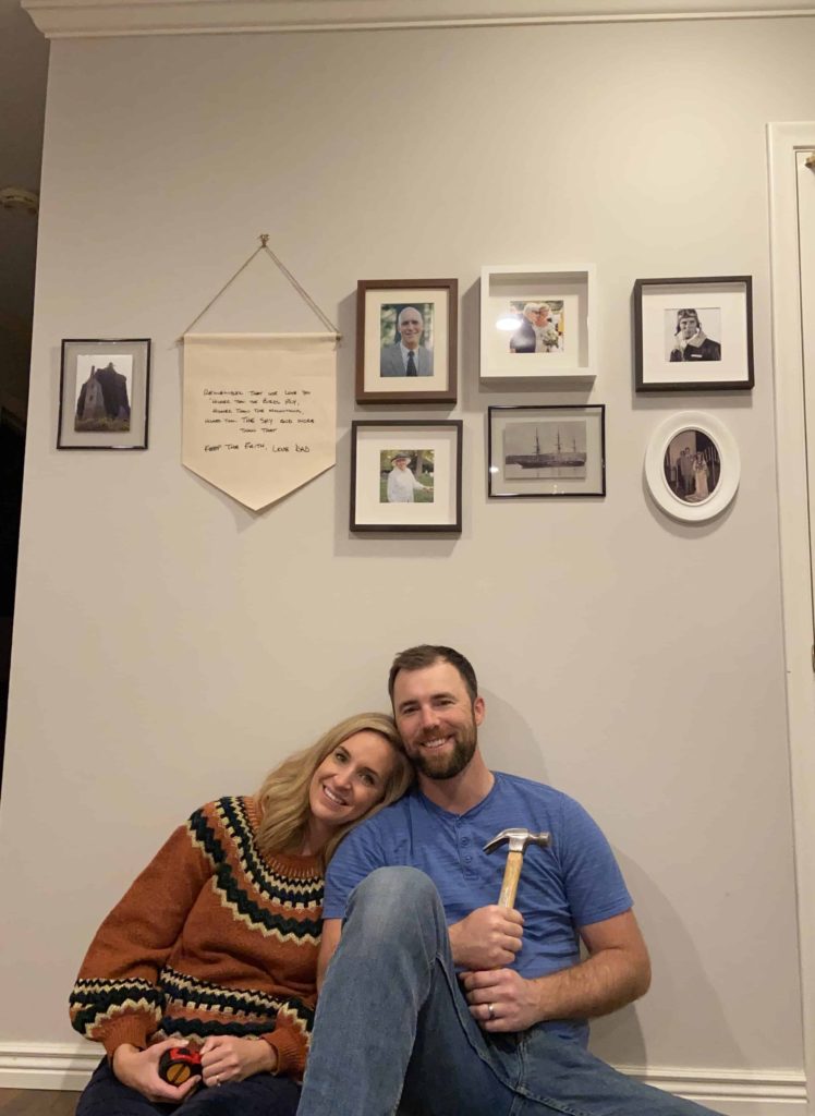 Brooke and Parker sitting beneath their completed ancestry gallery wall