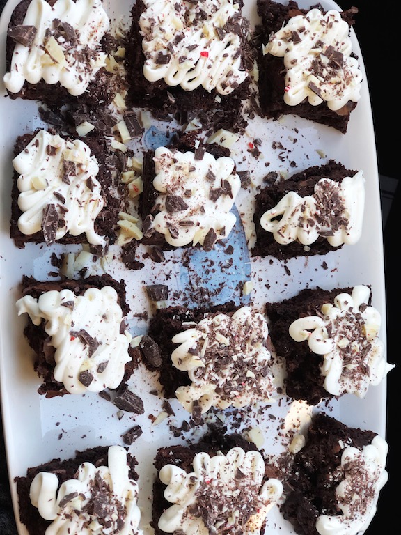tray of chocolate brownies with cream cheese frosting 
